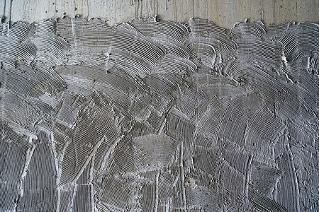 为 tilin 准备的混凝土墙梳表面胶水梳子平铺工作装修水泥砂浆灰色维修石头图片