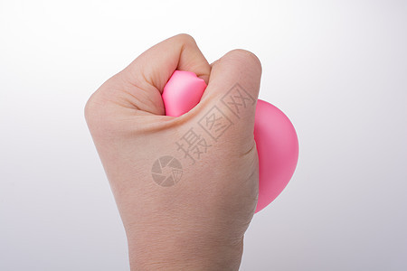 用手挤压粉红色气球挫折压力拳头活力概念紧张商业橡皮粉色焦虑图片