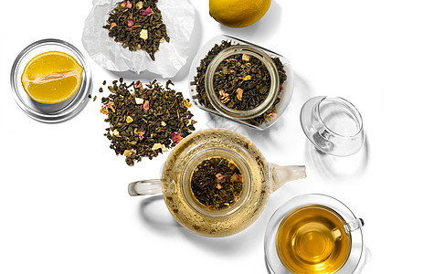 茶叶 茶壶 汤匙和白底柠檬图片