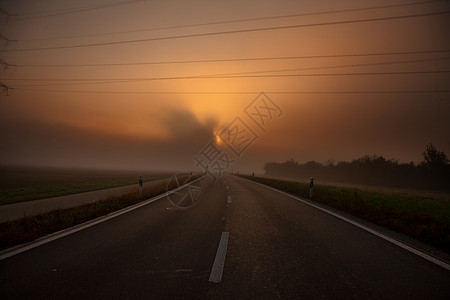 - 日出时有雾的公路图片