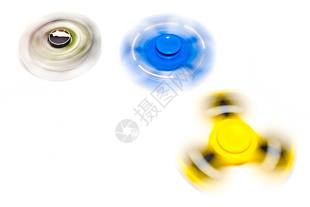 iddget 手旋转器在白色背景上旋转塑料压力工具玩具孩子们绿色蓝色滚筒黄色游戏图片