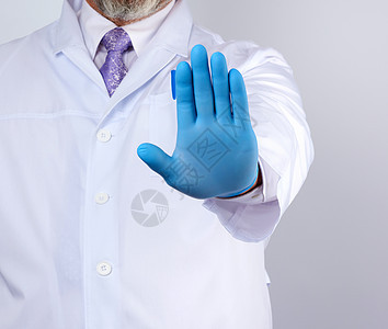 穿白大衣和蓝色消毒手套的男医生表示停止手术外套控制药品职业警告男性工人护士卫生疾病图片
