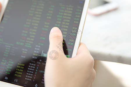 在平板上做网上交易 与繁忙的女性手图表金融商务电话市场股票女士贸易人士投资图片