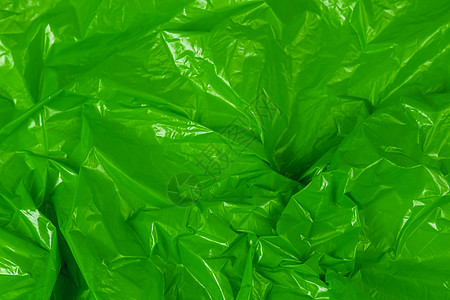 具有选择性聚焦的皱褶绿色聚乙烯薄膜抽象背景图片