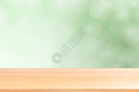 空木桌地板在模糊的散景软绿色渐变背景上 木板空在绿色散景彩色光罩上 彩色散景灯渐变软 用于横幅广告产品桌面坡度甲板柜台展示蓝色桌背景图片