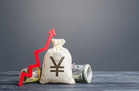 日元元钱袋子和向上的红色箭头 经济复苏和增长 经济上升的乐观预测 市场稳定 投资和资金的涌入 财富的增加 通胀上升背景图片