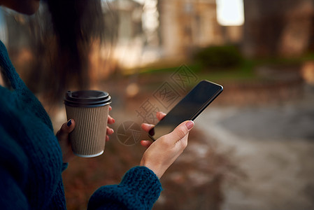 不明女性在远足时手持咖啡和移动电话纸杯的未知女性图片