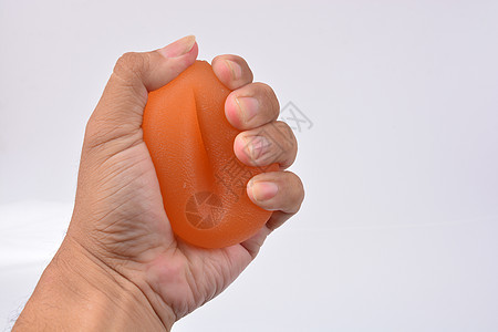 握着一个压压压力球的人的手 手力治疗器棒手指手腕商业拳头笔记本男性焦虑电脑技术橡皮图片