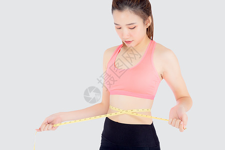 美丽又瘦又瘦的年轻女士 穿着薄腰带身体损失腰部锻炼腰围重量腹部训练健身房测量图片