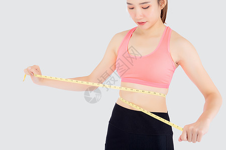 美丽又瘦又瘦的年轻女士 穿着薄腰带测量女孩锻炼女性重量身体腰部减肥训练运动图片