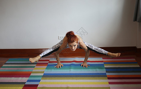 做运动的女孩妇女在家里做瑜伽冥想训练女士运动灵活性运动装练习身体女孩地面背景