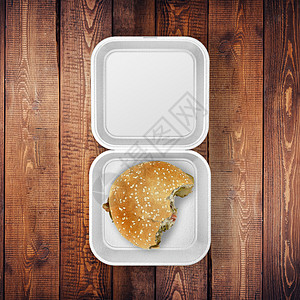 汉堡标识白色食品集装箱贴纸 在木板上涂有汉堡Bite Mockup背景