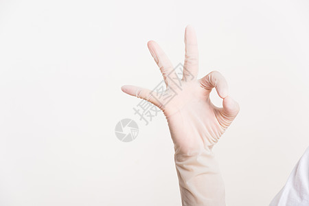 精准健康佩戴手对蓝橡皮手套 指头精准的女子背景
