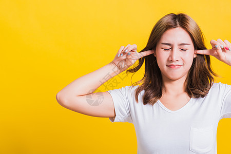 女人的笑容 有闭紧的掌耳朵和手掌女孩手势女士音乐头发压力生气噪音黄色女性图片