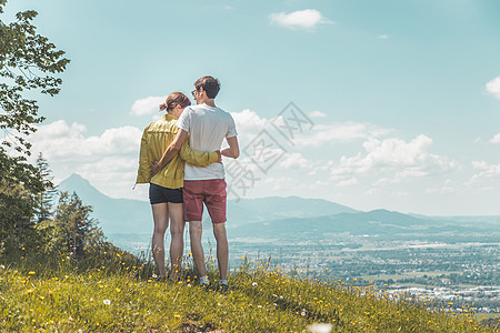 享受长河的山地风景 夫妇站在多河草原上 在遥远的萨尔茨堡市享受风景场景山链观光冒险山脉旅游登山城市质量高山图片