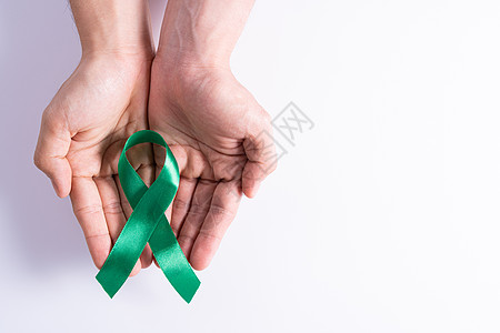世界肾日 握着绿丝带的手 对肾病的认识 孤立的白种背景药品活动输血保险机构世界橙子预防器官研究图片