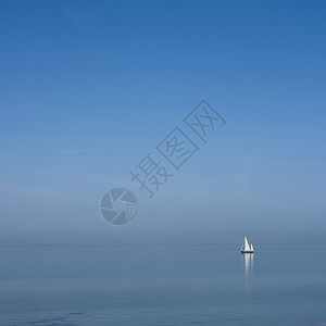 蓝色天空下广大空湖的蓝水上孤单帆船地平线海滩木头海岸孤独支撑钓鱼假期反射旅游图片