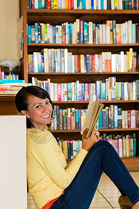 图书馆阅读书中的年轻女孩专注文章阅览室学习家庭作业文学考试学生智力女士图片