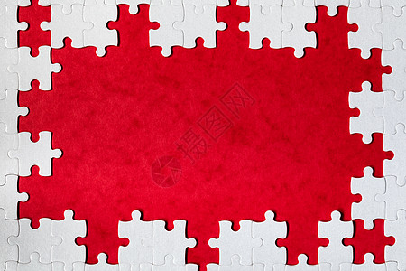框架由白色拼图制成的矩形形式 框架文本和拼图游戏 红色背景中由拼图块制成的框架空白解决方案挑战长方形创造力玩具团队构图游戏边界图片
