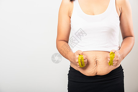 妇女使用节产后疤痕测量腰部妊娠纹松弛小腹皮肤她怀孕后婴儿出生发胖背景图片