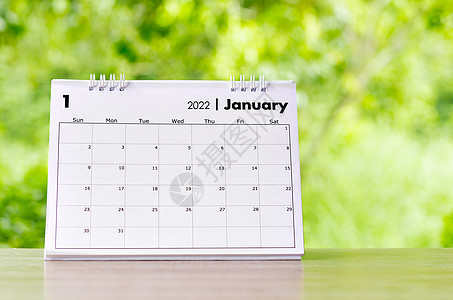 1月办公桌 2022年日历在木制桌上桌子季节规划师会议数字假期日记办公室背景议程图片