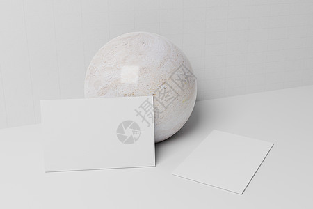 白色名片纸样机靠在大理石球体上 带有空白空间盖 用于在纸板背景上插入公司徽标或个人身份 现代文具概念 3D 插图渲染图片
