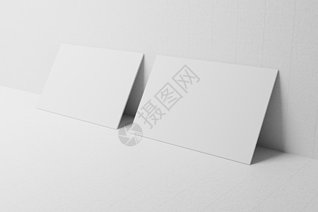 白色名片纸样机靠在带有空白空间封面的墙模板上 用于在纸板背景上插入公司徽标或个人身份 现代文具概念 3D 插图渲染图片