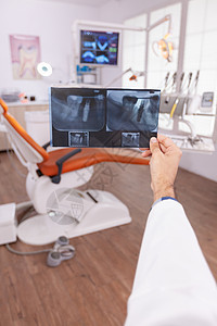 专门放射专家 在检查牙齿外科手术的手中掌握医疗牙齿射线成像术图片