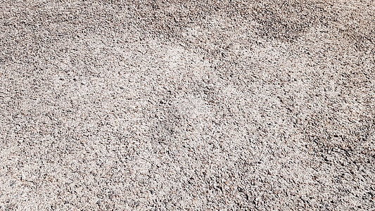 在自然光下被击碎的砾石纹理背景 用于背景或纹理的细灰色砾石 用于道路建设或景观建筑的天然建筑材料 建造业背景图片