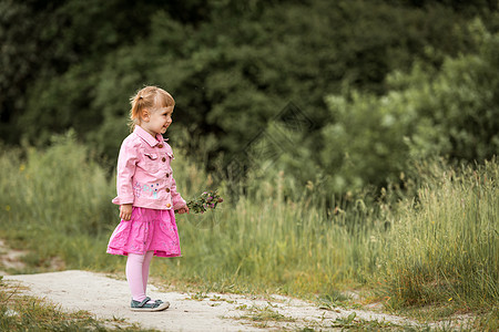 草地上的可爱小女孩孩子头发乐趣粉色眼睛童年后代女孩喜悦森林图片