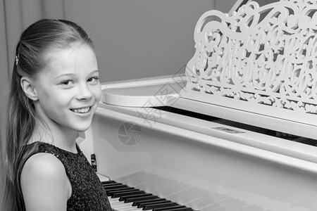 小姑娘弹钢琴 拍黑白相片乐器爱好女孩天赋演员蜡烛钢琴家音乐音乐会裙子图片