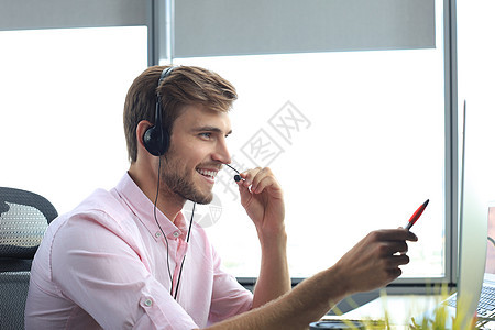 年轻男性客户快乐地支持执行官在办公室工作帮助电脑团队服务商务麦克风商业中心电话顾客图片
