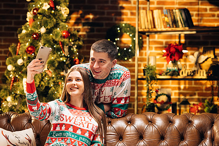 喜悦的男女夫妇在家 与装饰圣诞树在线视频聊天 向朋友和亲友表示节日问候 Xmas 晚会图片