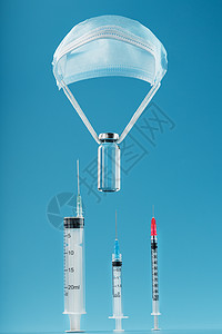 治愈病毒和疾病 用注射器在医疗擦油机上 在蓝色背景下注射图片