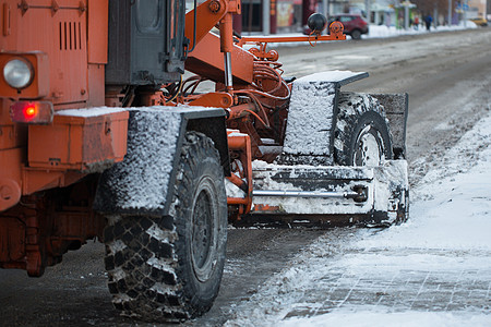 拖拉机从雪中清理道路 挖掘机清理城市中大量积雪的街道 工人在冬天从道路上扫雪 从暴风雪中清洁道路雪堆雪机卡车男人车轮路人机器清洁图片