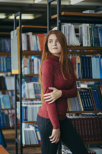 一个拿着书架的女孩 图书馆里的一个学生架子智力文学知识书柜女士中学智慧教科书教育图片