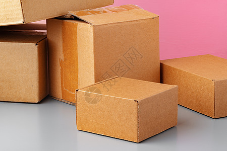 粉红色背景的一套纸板盒空白邮件店铺邮政工艺牛皮纸粉色礼物小样商业图片