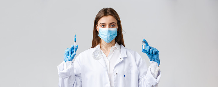 Covid19 预防病毒 医护人员和检疫概念 个人防护设备 医用面罩和制造冠状病毒疫苗注射 握持注射器和安瓿的磨砂膏的医生工人手图片