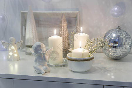 装饰圣诞节房子的概念 点燃蜡烛 园林 迪斯科舞团 白箱柜子上的天使雕像 文字放在何处框架帆布艺术品小样制品托盘陶瓷柳条烛台风格背景