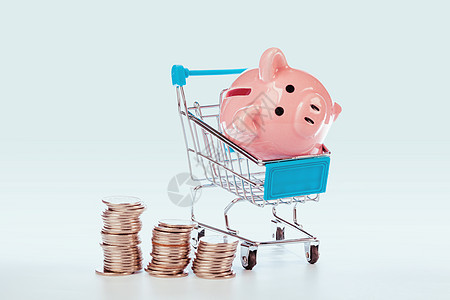 粉红小猪银行和白纸上孤立的硬币图片