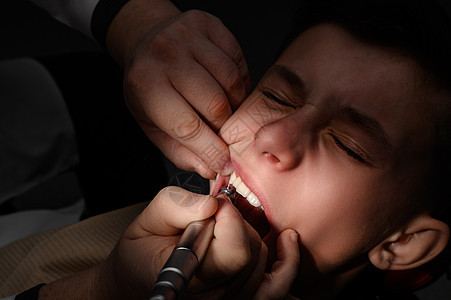 去看牙医 用钻头刷牙 一个小儿科牙医的男学生 他叫医生图片
