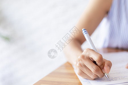 特写商业女性的手使用笔写文档纸 女性手在白纸上用蓝色钢笔写字 女人在一张纸上写信息笔记床单笔记本写作教育阅读学生商务合同女士图片