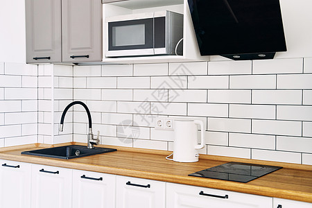 配有现代厨房木制柜子的白色橱柜抽屉财产家具器具内阁烤箱地毯房子公寓木头图片