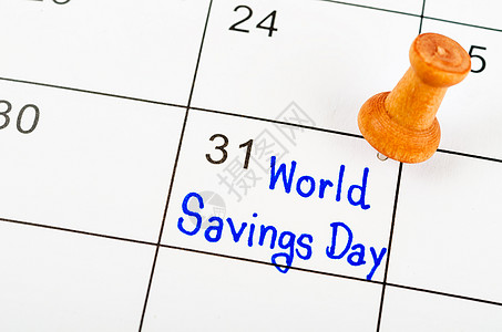 财经日历手写世界储蓄日 白日历上挂着木针背景