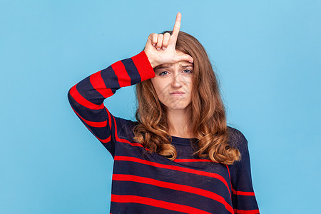女人表现失败的手势 L手指在额头上的标志 对解雇心烦意乱 不幸的一天图片
