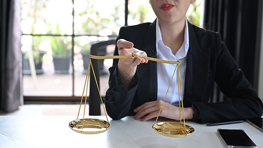 持有黄铜秤的律师或律师的裁剪图像 律师 正义和法律以及律师概念图片