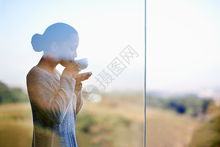 置身于大自然之中 品一杯暖暖的咖啡 透过窗户拍摄一位年轻女子站在户外喝咖啡的照片黑发女士女性饮料玻璃消耗品成人身材茶杯休闲服背景图片