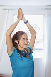 缓解压力 肌肉放松 呼吸练习 锻炼 冥想 亚洲年轻女性的肖像通过观看在线教程练习瑜伽来放松她在办公室工作中的身体灵活性隔膜女孩健图片