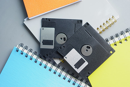 灰色背景上的老旧软盘代码塑料记忆记录办公室技术数据读者光盘软件图片