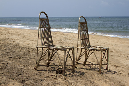 在海滩上站着两张小椅子 等待人们在海面对岸图片
